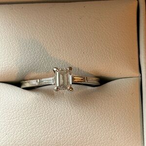 White gold and emerald cut diamond engagement ring